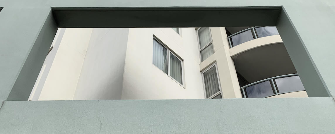 Apartments through a concrete window.