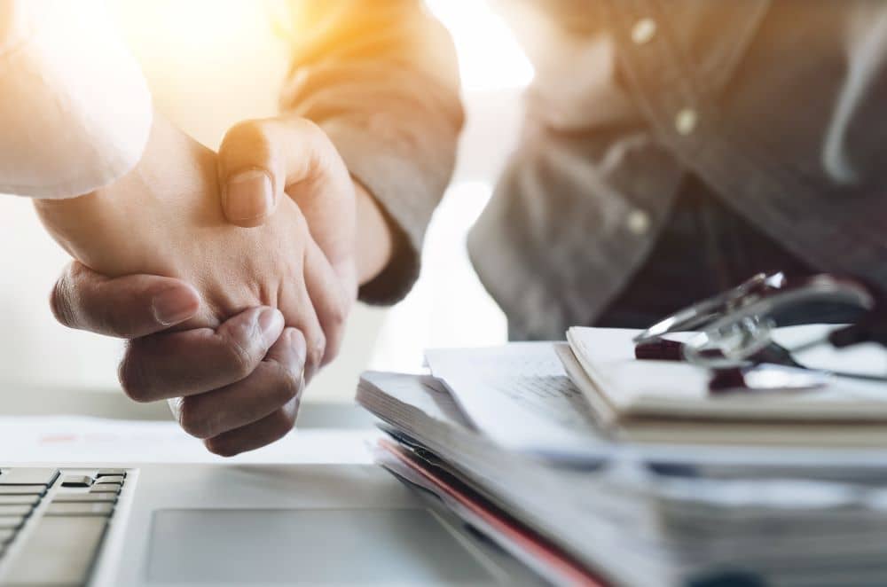 Businessmen shaking hands after meeting.