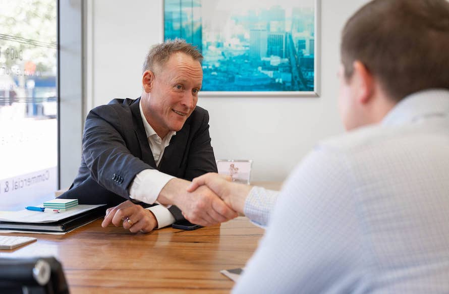 Licensed private lender shaking a client's hand